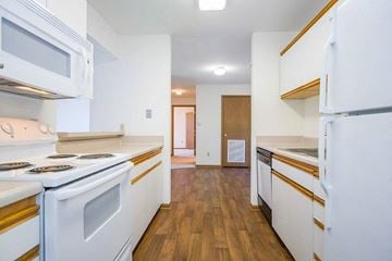 Lawrence apartment for rent - A kitchen with white appliances and wooden floors.