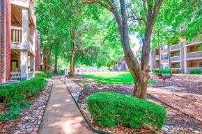 Tulsa apartment for rent - Exterior of apartment with tree-lined view and walking paths at Greenbriar Apartments, Tulsa, 74136