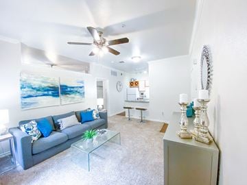 Dallas apartment for rent - a living room with a couch and a ceiling fan