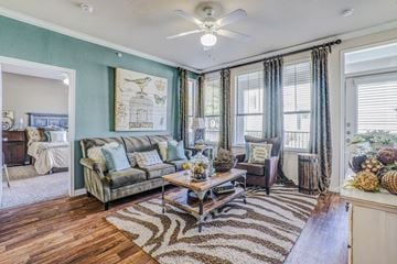 Frisco apartment for rent - a living room with blue walls and a ceiling fan