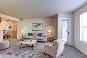 Tulsa apartment for rent - A living room with a white couch, a coffee table, and a painting on the wall.