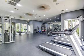 Tulsa apartment for rent - A spacious gym with treadmills, weights, and other exercise equipment.