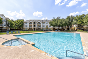 Dallas apartment for rent - A large swimming pool in front of apartment buildings.