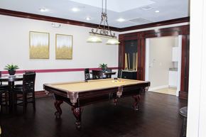 Dallas apartment for rent - Wooden billiards table, with dark wood flooring and seating area at Montfort Place Apartments, Dallas 75254