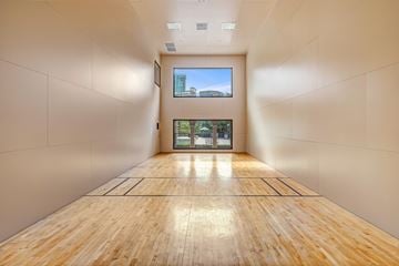 Dallas apartment for rent - A long hallway with wooden floors and white walls.