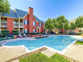 Dallas apartment for rent - Outdoor swimming pool on a sunny day at SaddleBrook Apartments, Dallas, TX, 75248