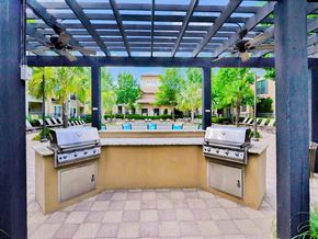 Irving apartment for rent - Outdoor grilling area with a blue covering at Mission at La Villita Apartments, Irving, TX