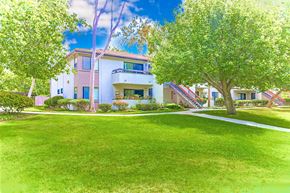 Encinitas apartment for rent - Exterior of apartment with green lawn and trees at Village Park Apartments, California, 92024