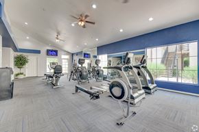 Scottsdale apartment for rent - A gym with a variety of exercise equipment and a ceiling fan. at Ventana, Scottsdale, 85260