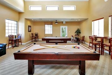 Tucson apartment for rent - a game room with a pool table and two billiard tables