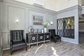 Los Angeles apartment for rent - a lobby with black leather chairs and a table with a mirror