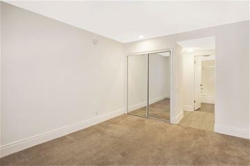 Los Angeles apartment for rent - a living room with a carpet and a glass closet