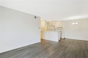 Los Angeles apartment for rent - the living room and kitchen of an apartment with white walls and wood flooring