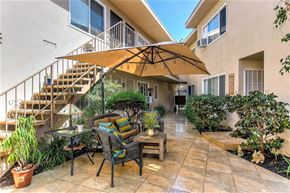 Los Angeles apartment for rent - A patio with a table and chairs under a large umbrella.