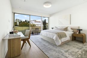 Los Angeles apartment for rent - a bedroom with a bed and a desk and sliding glass doors