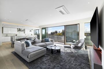 Los Angeles apartment for rent - a living room with a gray rug and a gray couch