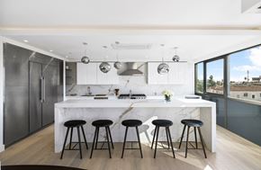 Los Angeles apartment for rent - a kitchen with a marble counter top and bar stools