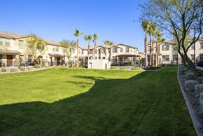 Mesa townhouse for rent - A large grassy area in front of a row of houses.
