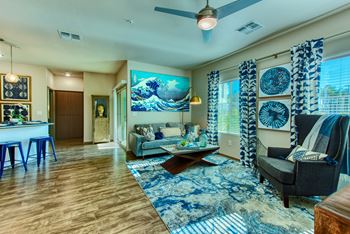 A living room with a blue and white rug on the floor.