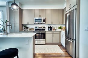 Gilbert apartment for rent - a kitchen with stainless steel appliances and white cabinets at Elevation at the Village, Gilbert, AZ 85295