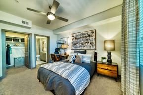 Gilbert apartment for rent - a bedroom with a bed and a ceiling fan at Elevation at the Village, Arizona, 85295