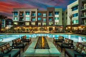 Gilbert apartment for rent - a swimming pool at night with an apartment building in the background at Elevation at the Village, Gilbert, 85295