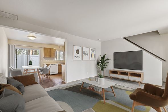 Post Falls townhouse for rent - a living room with a couch a coffee table and a tv on the wall