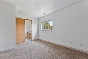 Post Falls townhouse for rent - a bedroom with white walls and carpet