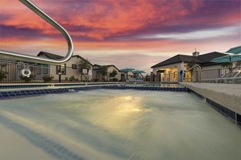 A swimming pool with a sunset in the background.