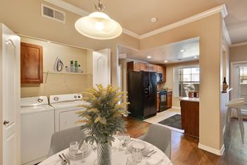 A kitchen with a table set for two and a pineapple centerpiece.