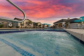 Gilbert apartment for rent - a large swimming pool with a sunset in the background at Villas on Ash Apartments, Gilbert, AZ, 85234