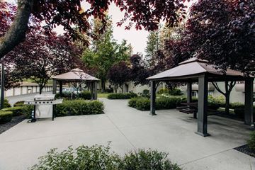 Coeur D'alene apartment for rent - A park with a gazebo and benches surrounded by trees.