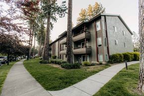 Coeur D'alene apartment for rent - the side of a building with a sidewalk and trees