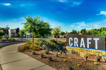 A sign for craft apartment  at craft at gilbert and baseline apartments, mesa, 85204 living stands in front of a building1