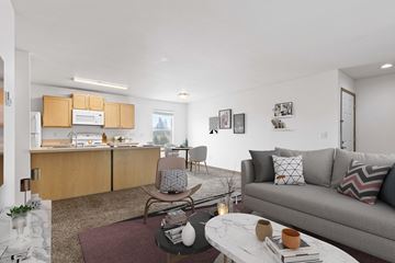 Coeur D’Alene apartment for rent - a living room with a couch and a table and a kitchen