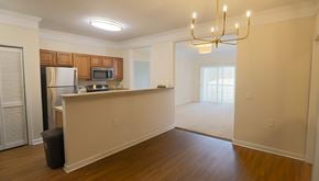 Fredericksburg apartment for rent - A kitchen with wooden cabinets and a refrigerator.