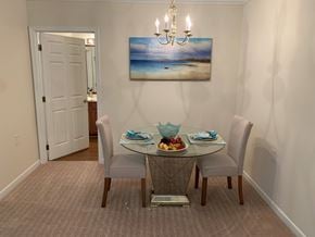 Fredericksburg apartment for rent - A dining room with a glass table and chairs.