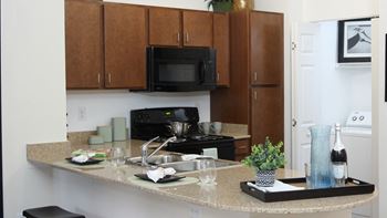 Sleek, shaker-style maple cabinetry in kitchens &  baths
