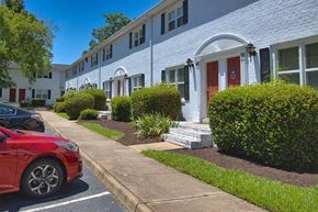 Newport News townhouse for rent - A red car is parked on the side of a street.