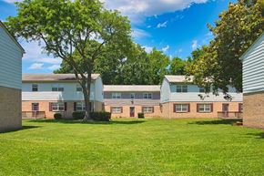 Hampton apartment for rent - A grassy area in front of a building with trees.