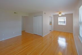 Hampton apartment for rent - A room with wooden floors and white walls.