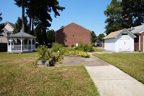 Hampton apartment for rent - A white gazebo is in the middle of a grassy area.