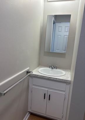 Newport News apartment for rent - A white bathroom with a sink and a mirror.
