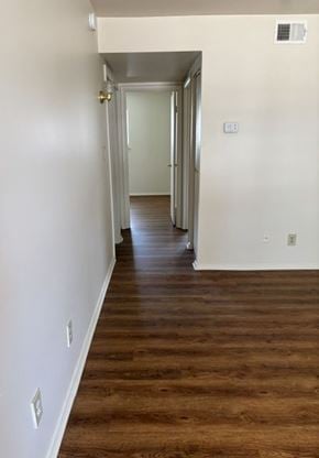 Newport News apartment for rent - A long hallway with wood floors and white walls.