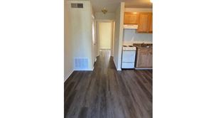Newport News apartment for rent - a view of a kitchen and a hallway with wood floors