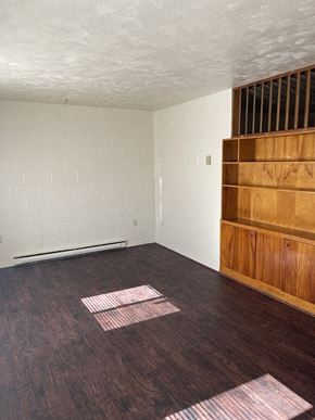Newport News apartment for rent - an empty living room with wooden floors and white walls