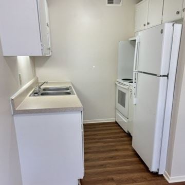 Newport News apartment for rent - A small kitchen with a sink, stove and refrigerator.