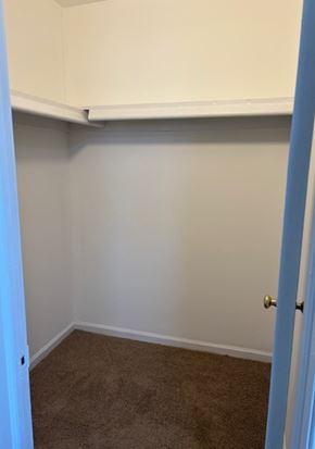 Newport News apartment for rent - A room with a carpeted floor and a white door.
