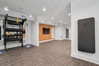 The living room has a large screen tv and a fireplace