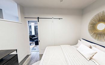 Rendering of barn door and partial wall in open concept one bedroom apartment 
